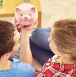 couple looking at piggy bank