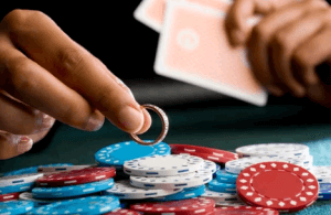 Man exhibiting bad casino habits of using his wedding ring to gamble