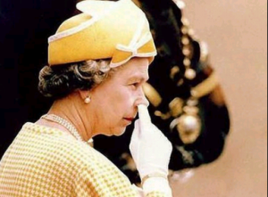 Queen Elizabeth II in yellow picking her nose with her white gloves
