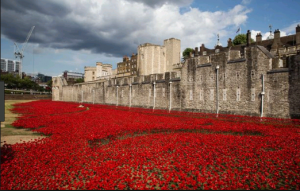 The image shows red handmade poppies that will be used to mark and celebrate the WWI