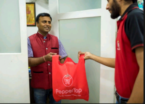 The image shows a man who is being handed his plastic bag with food by a delivery guy