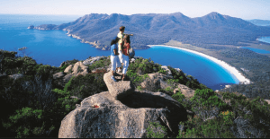 The image shows people taking a glance at the beautiful view from a mountain top in Australia